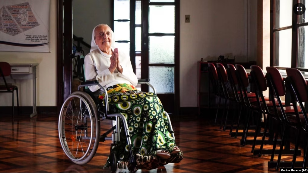 In this photo released by LongeviQuest, Sister Inah Canabarro, 115, puts her hands together in prayer, in Porto Alegre, Brazil, Friday, February 16, 2024. (Carlos Macedo/LongeviQuest, via AP)