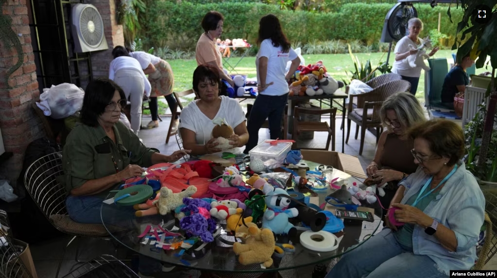 Volunteers restore used toys to donate them to vulnerable children as Christmas presents, at the non-profit foundation Hospital de los Peluches, or Hospital of Stuffed Animals, in Caracas, Venezuela, Thursday, Dec. 5, 2024. (AP Photo/Ariana Cubillos)