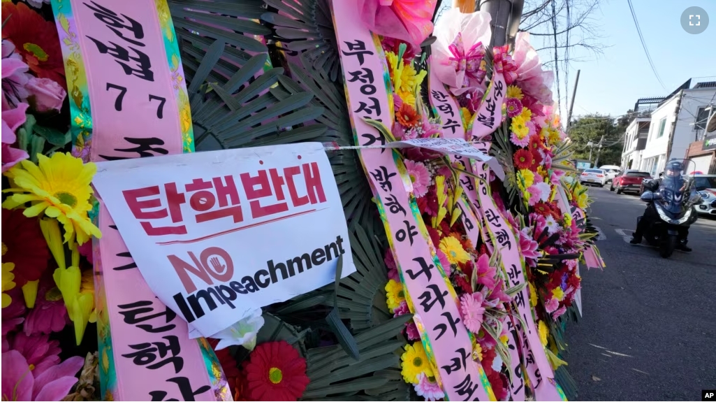 Wreaths sent by supporters of impeached South Korean President Yoon Suk Yeol are displayed outside the Constitutional Court in Seoul, South Korea, Friday, Dec. 27, 2024. (AP Photo/Ahn Young-joon)