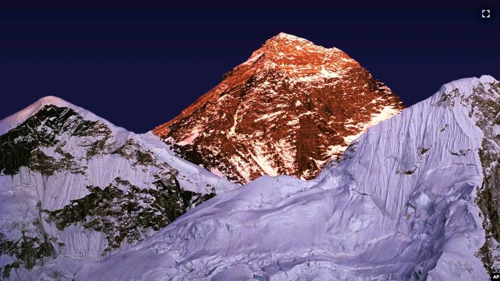 FILE - A golden glow is cast as the sun sets on the worlds highest mountain, center, seen from Kalapathar, on the trail to Everest, Nepal, Tuesday Nov. 15, 1983. (AP Photo/Bikas Das)