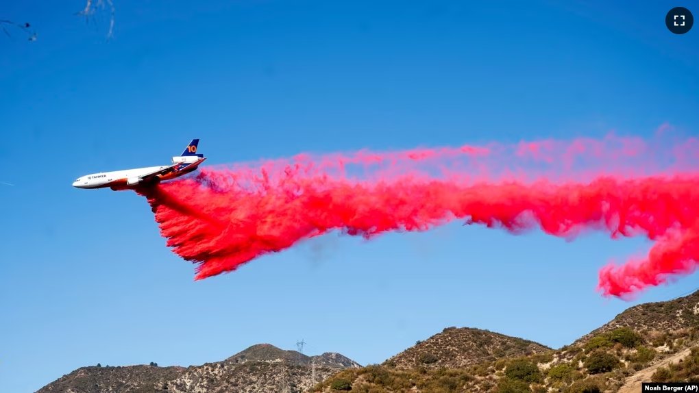 An air tanker drops retardant while working to contain the Eaton Fire in Altadena, Calif., Monday, Jan. 13, 2025.