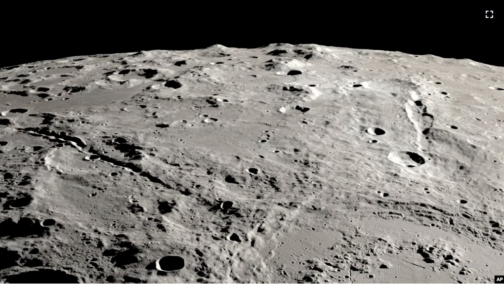 This image provided by NASA shows a view from orbit looking across the surface of the moon, where an ancient asteroid strike carved out a pair of grand canyons on the moon’s far side. (Ernie T. Wright/NASA via AP)