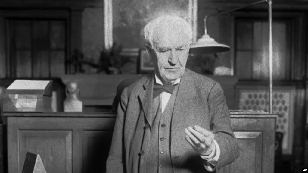 File - Thomas Edison presses a button in West Orange, N.J., in 1928. The button turns on street lights in Seattle. (AP Photo)