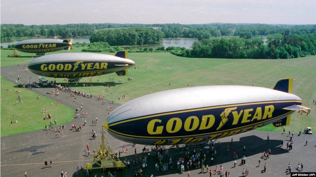 In this June 18, 1998 file photo, three Goodyear blimps, the then newly commissioned Stars and Stripes, foreground, the decommissioned Stars and Stripes, middle, and the Spirit of Akron are moored at the Goodyear blimp base in Suffield, Ohio. (AP Photo/Jeff Glidden)